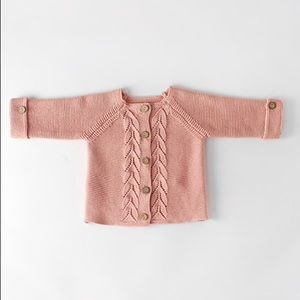 Pink knit cardigan.